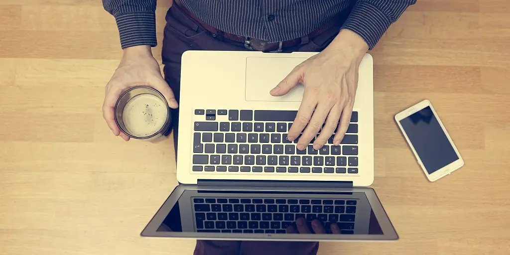 Top,View,Of,Young,Adult,Working,On,Laptop,Computer,And