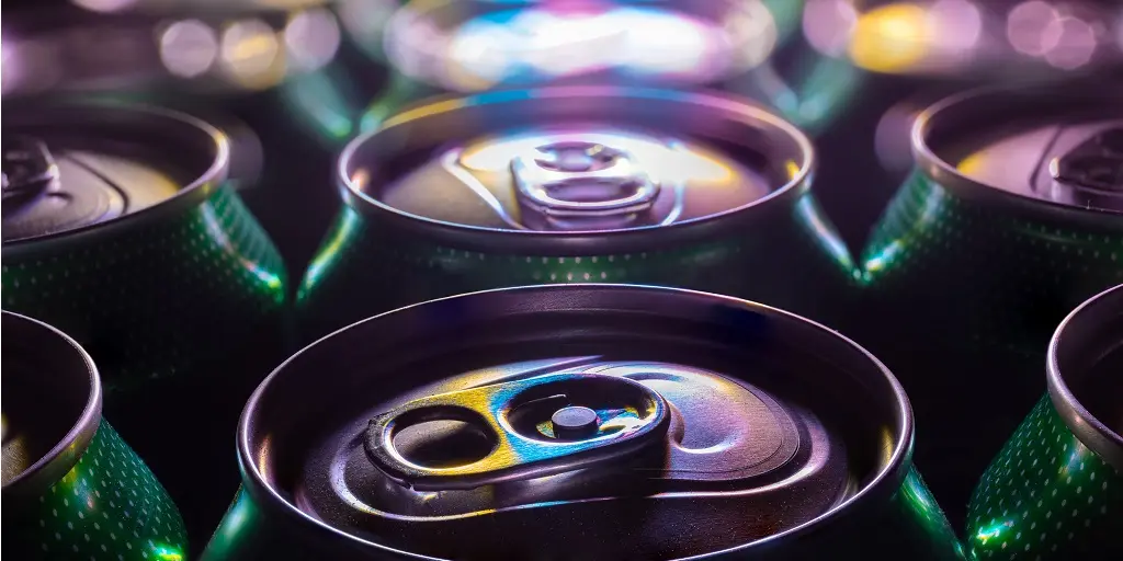 A,Close-up,Of,Green,Beer,Cans,Lit,With,Colorful,Light.