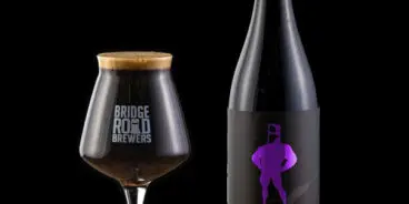 A glass and a bottle of B2 Bomber Mach 13 by Bridge Road Brewers