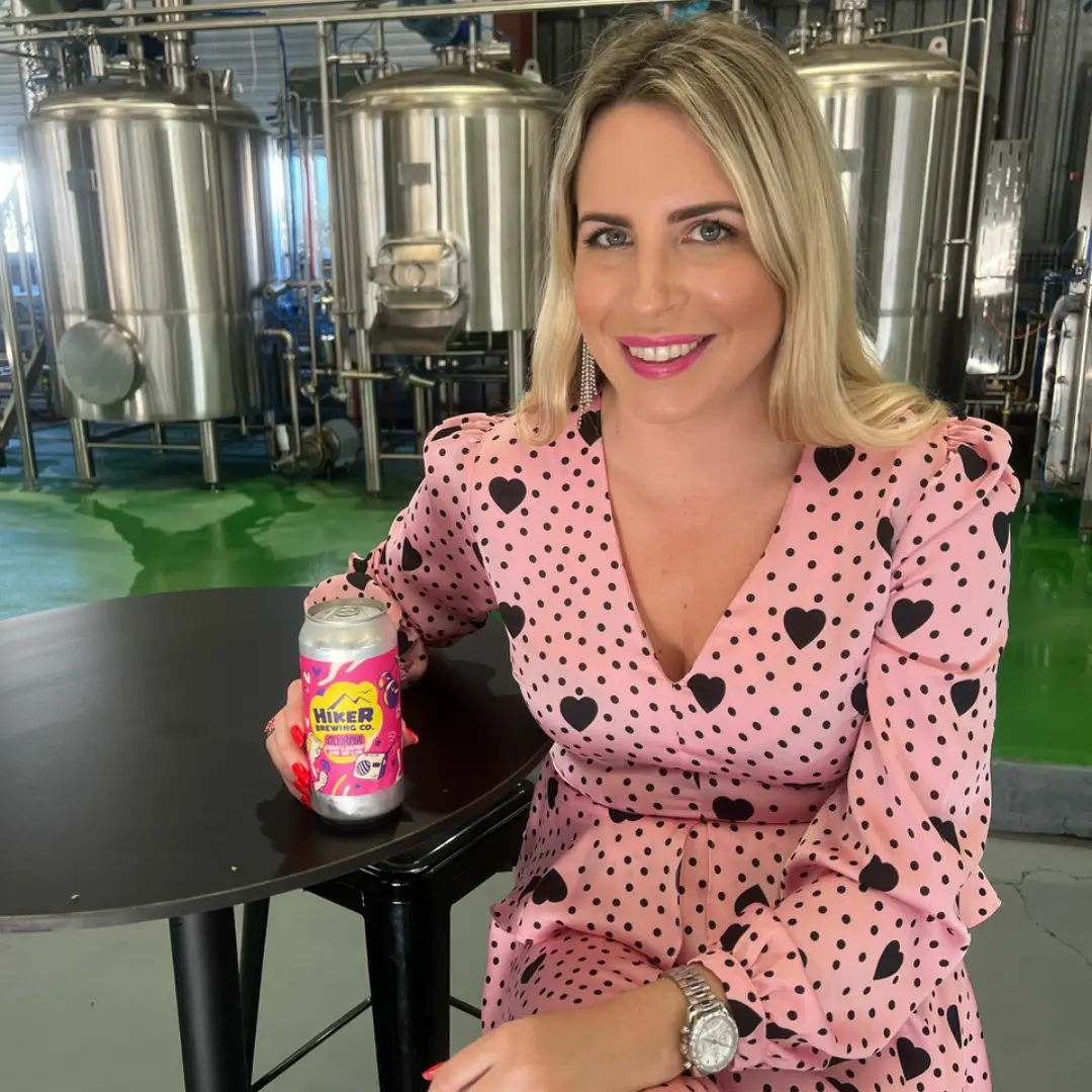 Olympia Kwitowski from 4BC Brisbane holding Hiker Brewing beer