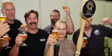 People holding up beers and signs at the Royal Queensland Beer Awards