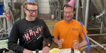 Two founders of KAIJU! Beer celebrating the brewery's 10th birthday