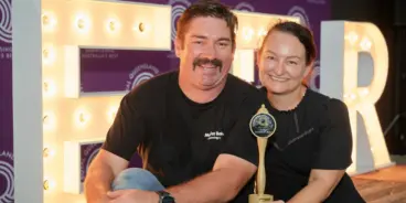 Shaz and Matt Wilson from Moffat Beach Brewing Co holding their Royal Queensland Beer Awards trophy