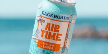 Can of Air Time Low Carb Lager by Gage Roads with ocean in background