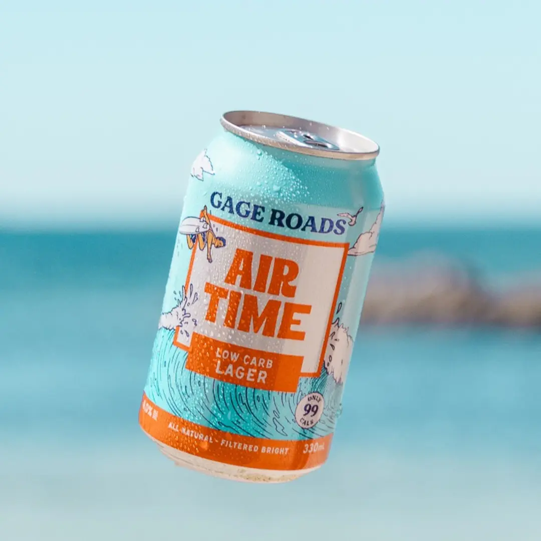 Can of Air Time Low Carb Lager by Gage Roads with ocean in background